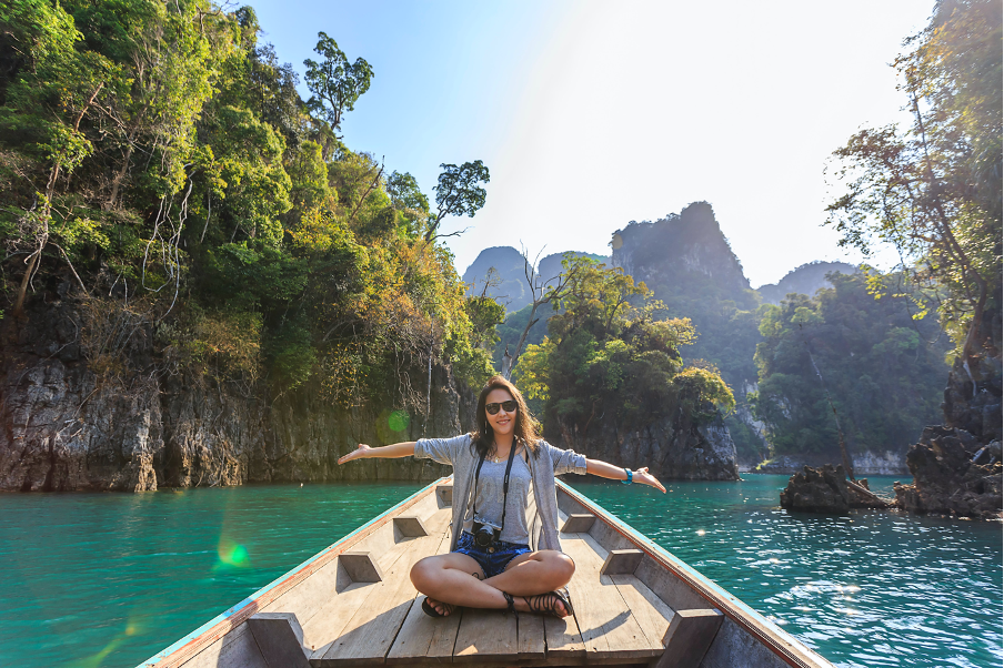 Woman at boat in see in warm country